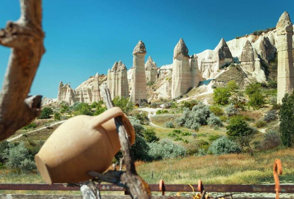 Unique geological formations in Love Valley in Cappadocia against blue sky in summer. Popular touristic area in Goreme, Nevsehir, Turkey